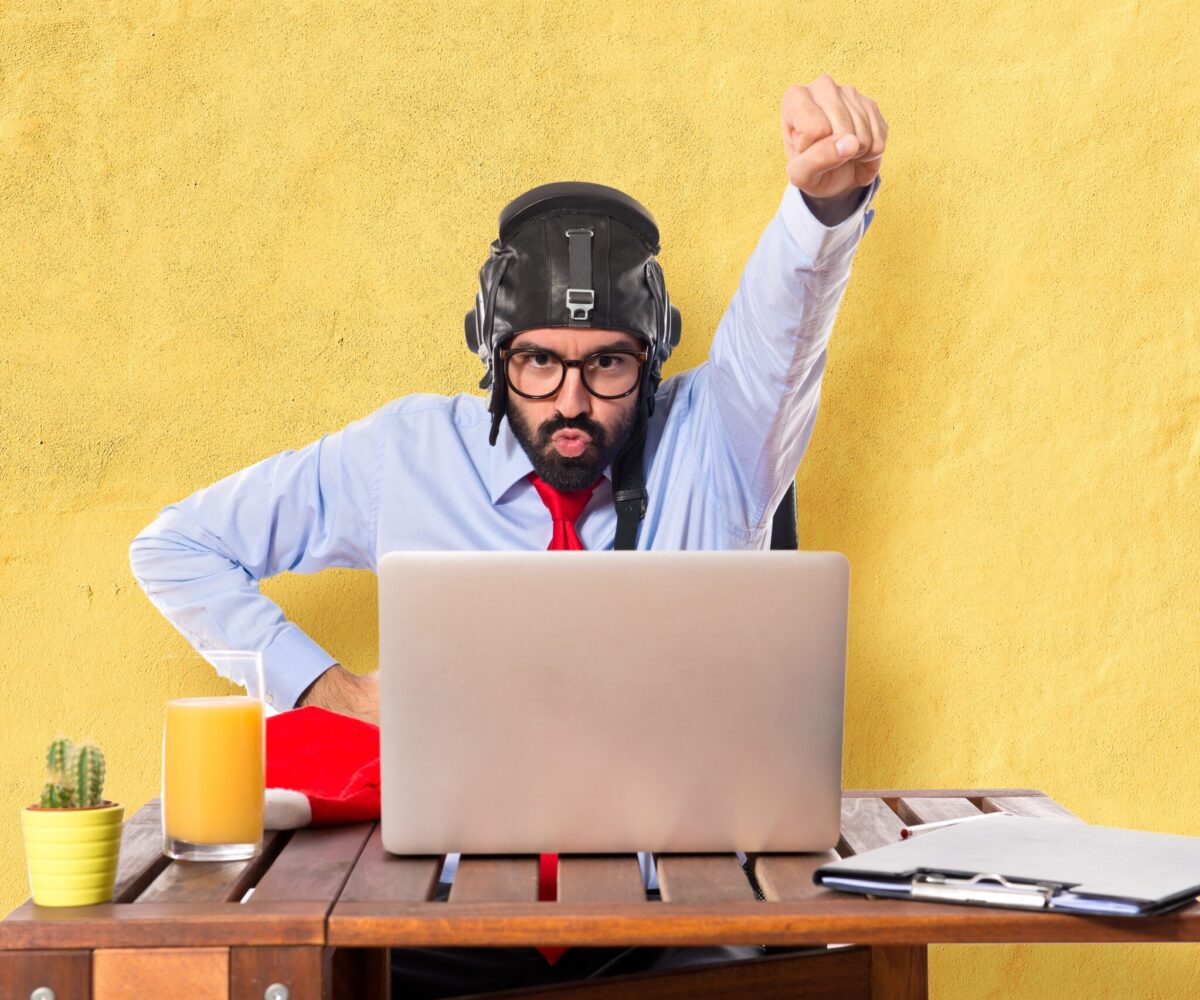 Businessman in his office with pilot hat